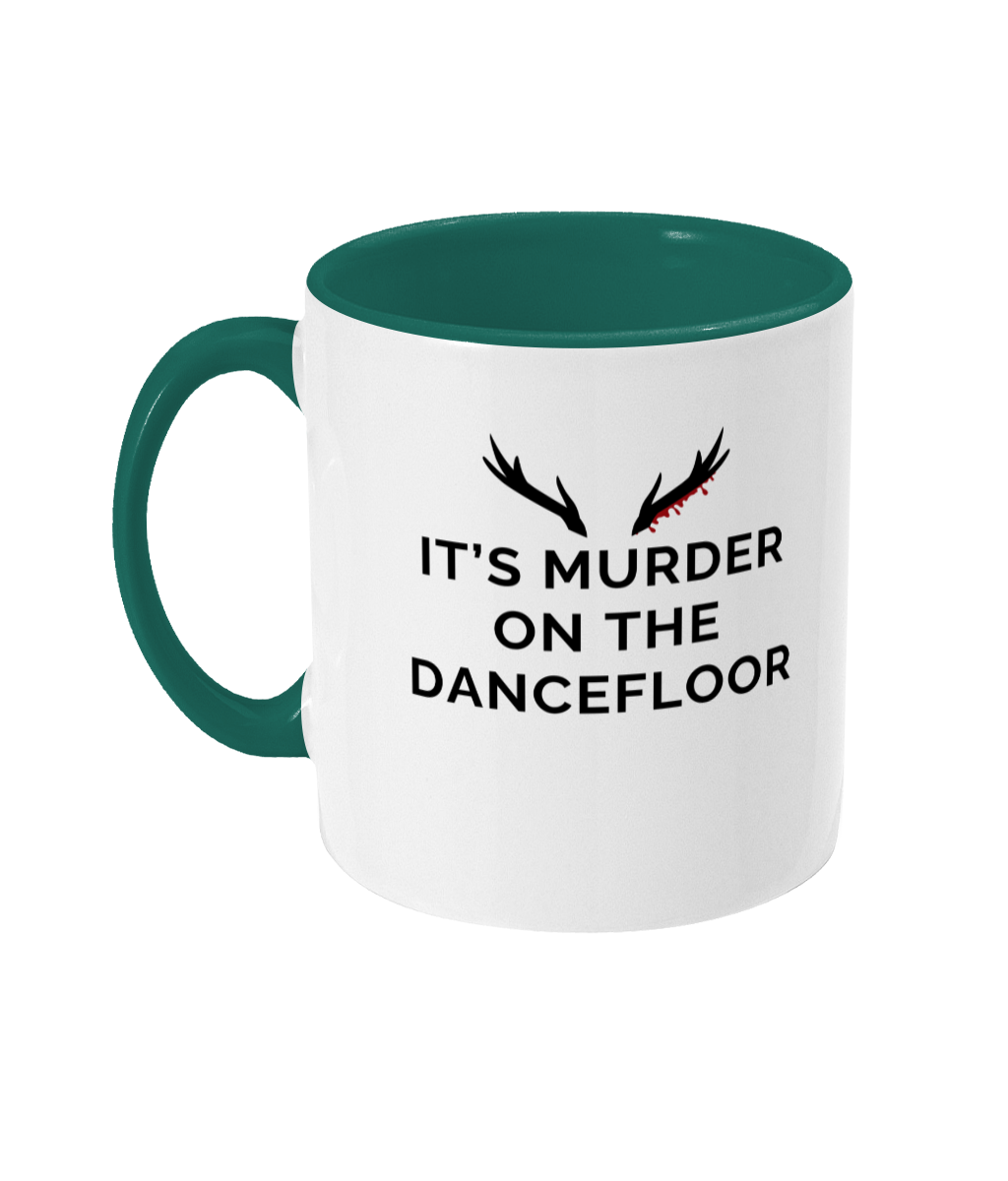Mug with a green handle and green inner that reads "It's Murder On The Dancefloor" with antlers above the text with blood drips coming from the right bottom antler