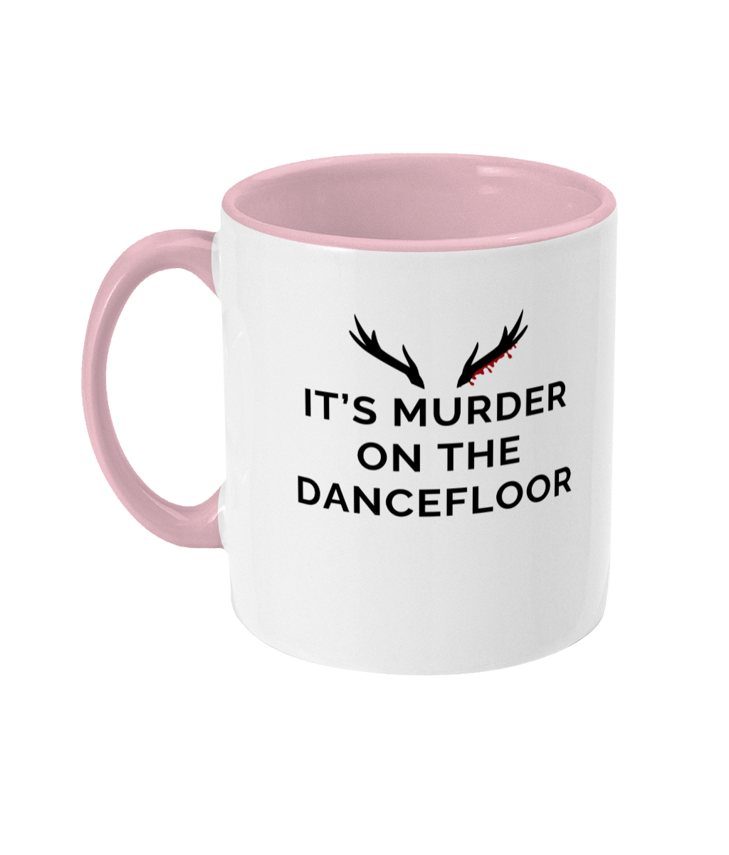 Mug with a pink handle and pink inner that reads "It's Murder On The Dancefloor" with antlers above the text with blood drips coming from the right bottom antler
