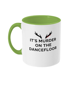 Mug with a light green handle and light green inner that reads "It's Murder On The Dancefloor" with antlers above the text with blood drips coming from the right bottom antler