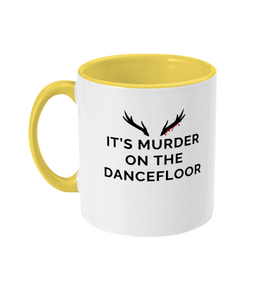 Mug with a yellow handle and yellow inner that reads "It's Murder On The Dancefloor" with antlers above the text with blood drips coming from the right bottom antler
