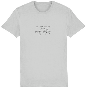 Heather grey Organic T-Shirt that says: Murder shows and comfy clothes. Murder shows is in all caps in a serif font, and comfy clothes is in a handwriting style font 