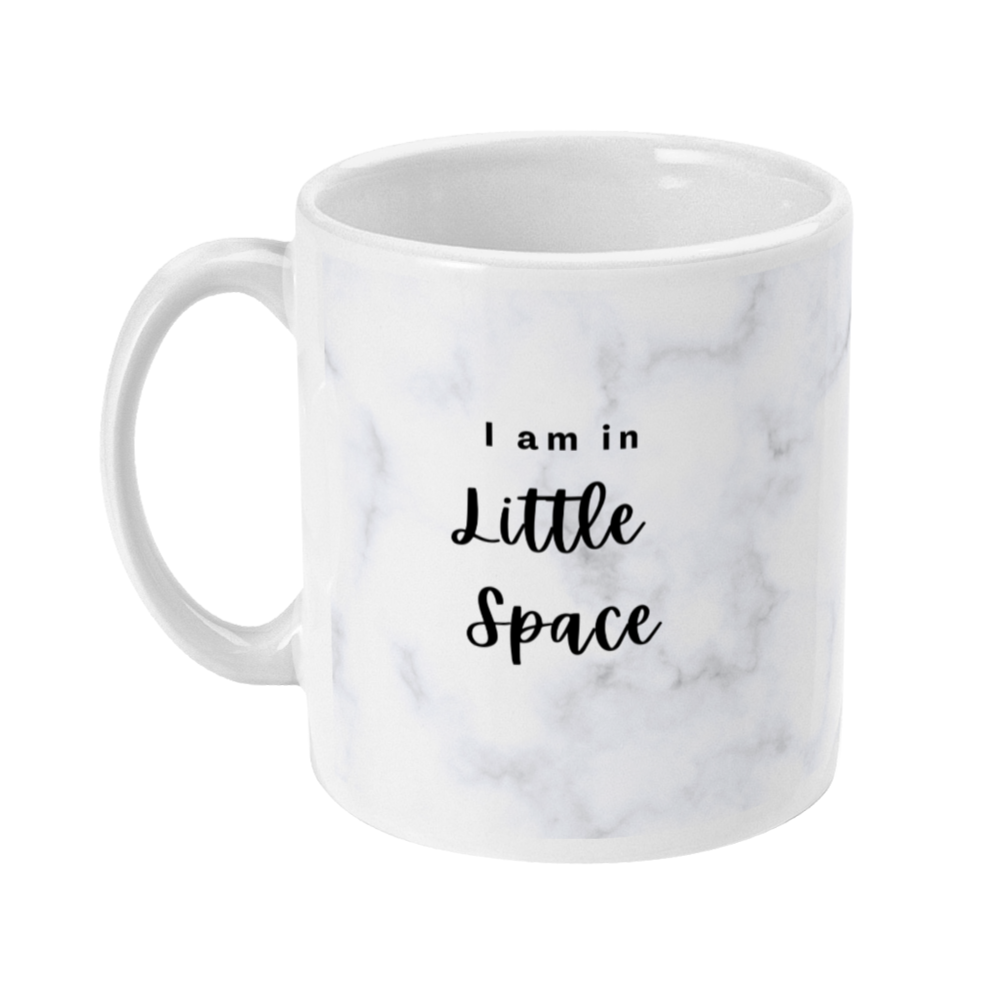 Mug with light marble print on that says: I am in little space