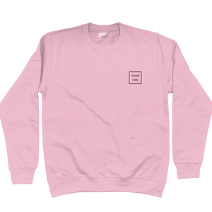 Baby pink Home Girl sweatshirt. Home Girl in a box in all capitals sans serif font. Home Girl is placed top left of the chest]