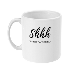 Mug that says: Shhh I'm introverting. Shhh is in large script text, and I'm introverting is in small sans serif text underneath