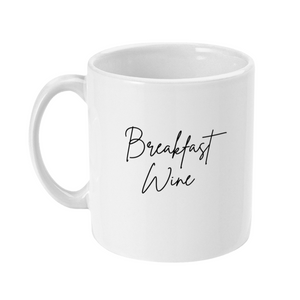 Mug that reads Breakfast Wine in a handwriting style text