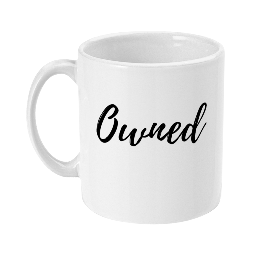 Mug with text on in a script style that says: Owned