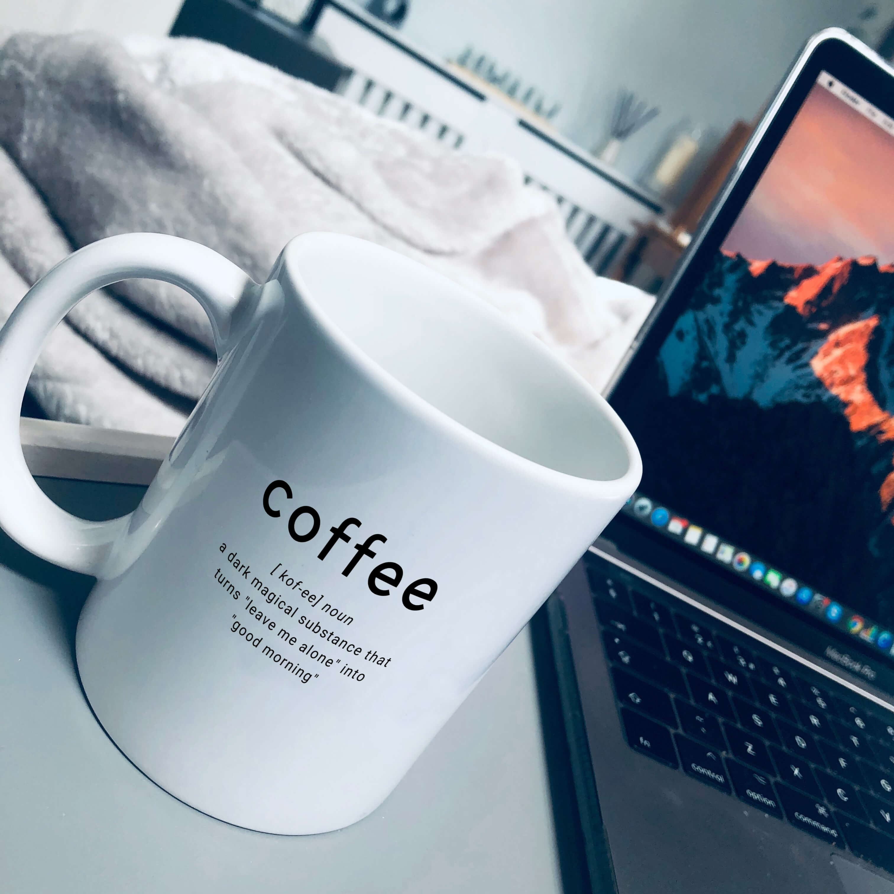 Coffee mug. Mug has coffee in larger text, with text underneath that says: a dark magical substance that turns leave me alone into good morning