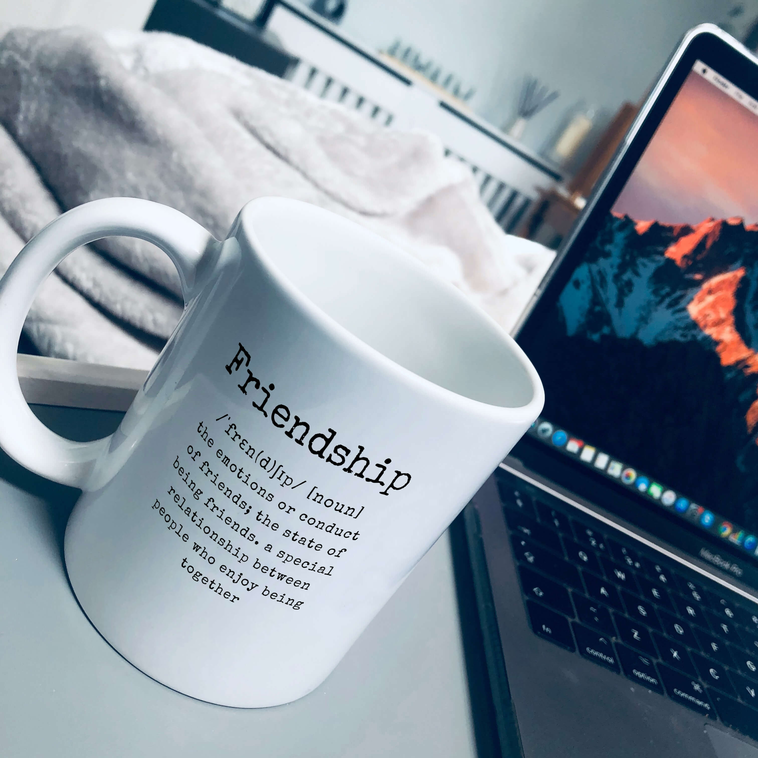 Mug reads Friendship /ˈfrɛn(d)ʃɪp/ [noun] the emotions or conduct of friends; the state of being friends. a special relationship between people who enjoy being together
