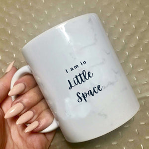 Mug with light marble print on that says: I am in little space  Edit alt text