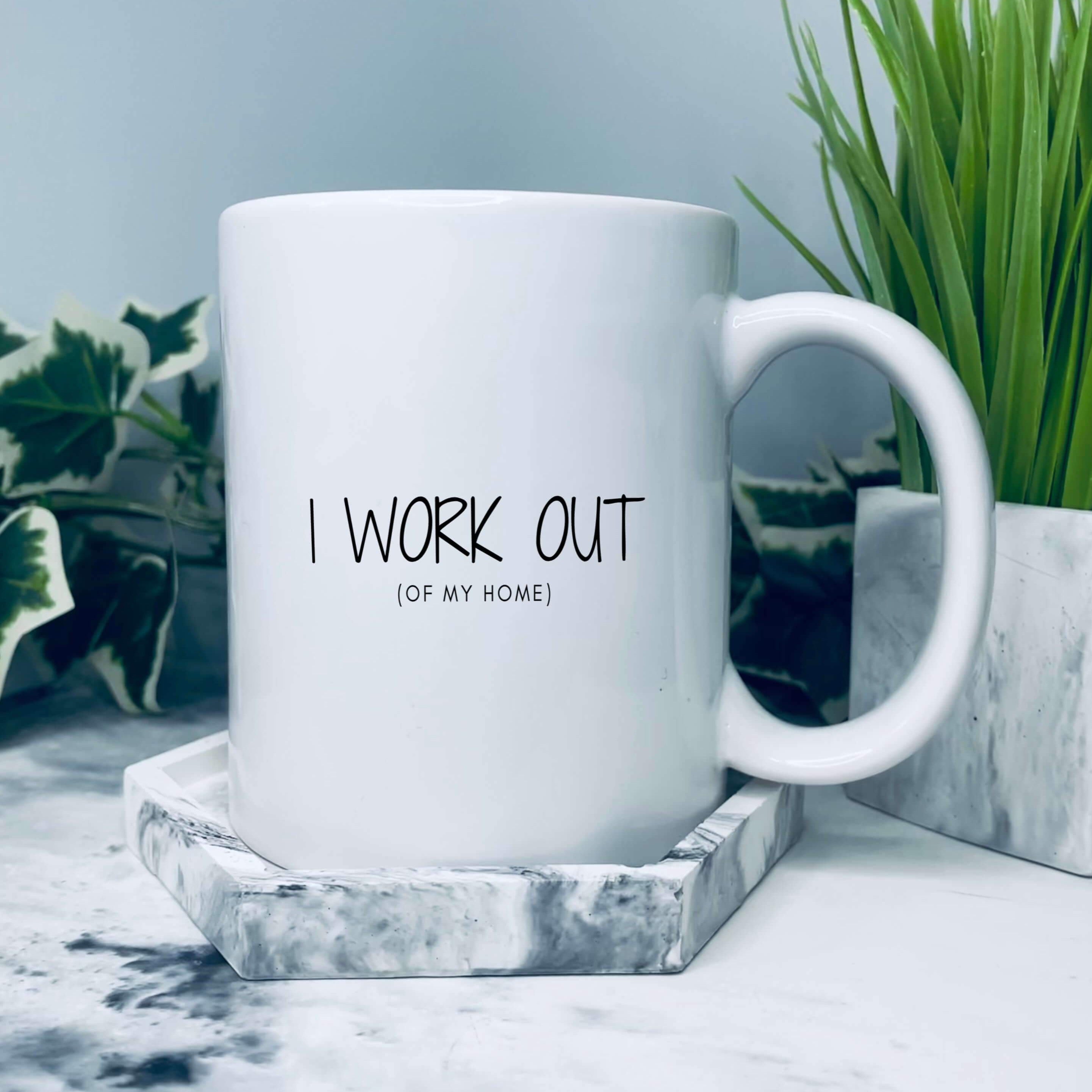 Mug with text on that says: I work out (of my home)