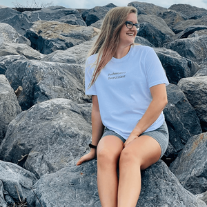 Arctic White Organic T-Shirt that reads professional overthinker in a typewriter style font. Professional Thinker takes up the middle section of the chest and is a small style size to not take up to much of the t-shirt