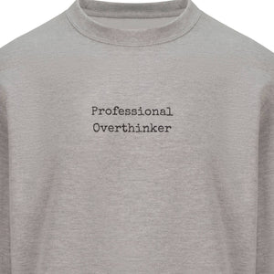 Sweatshirt that has "Professional Overthinker" in typewriter style font