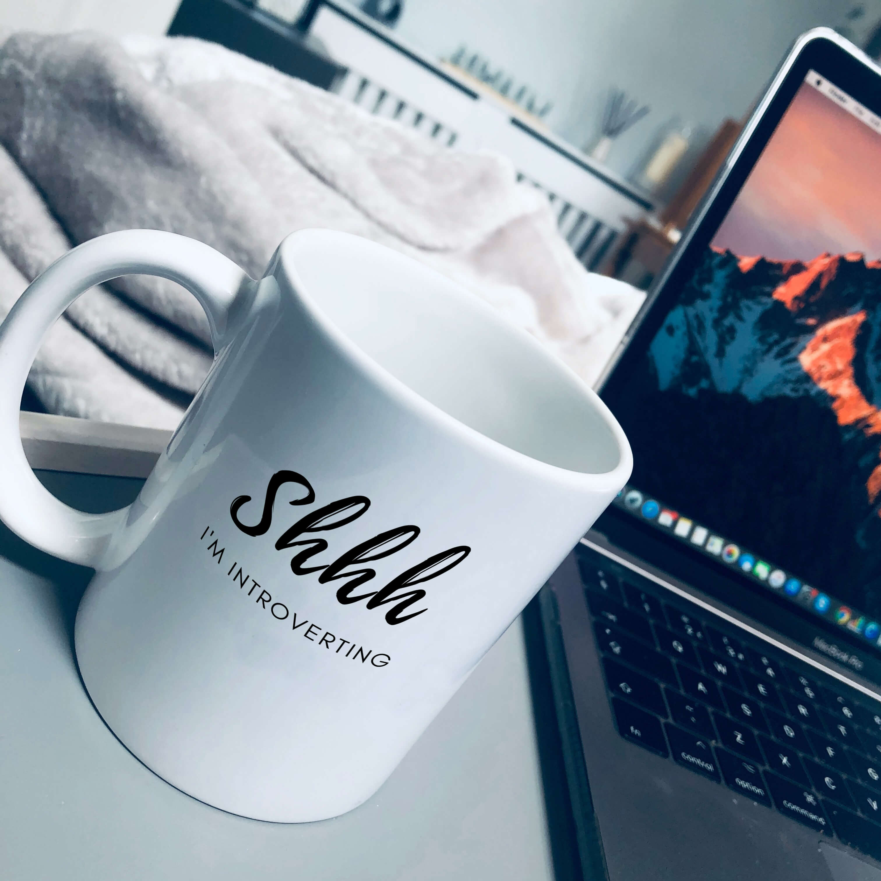Mug that says: Shhh I'm introverting. Shhh is in large script text, and I'm introverting is in small sans serif text underneath