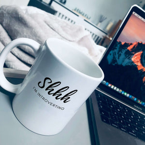 Mug that says: Shhh I'm introverting. Shhh is in large script text, and I'm introverting is in small sans serif text underneath