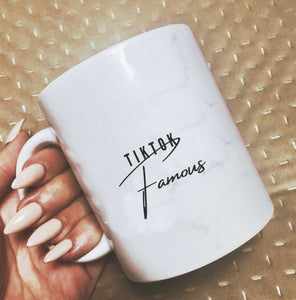 Mug with a light marble print on that says: TikTok Famous