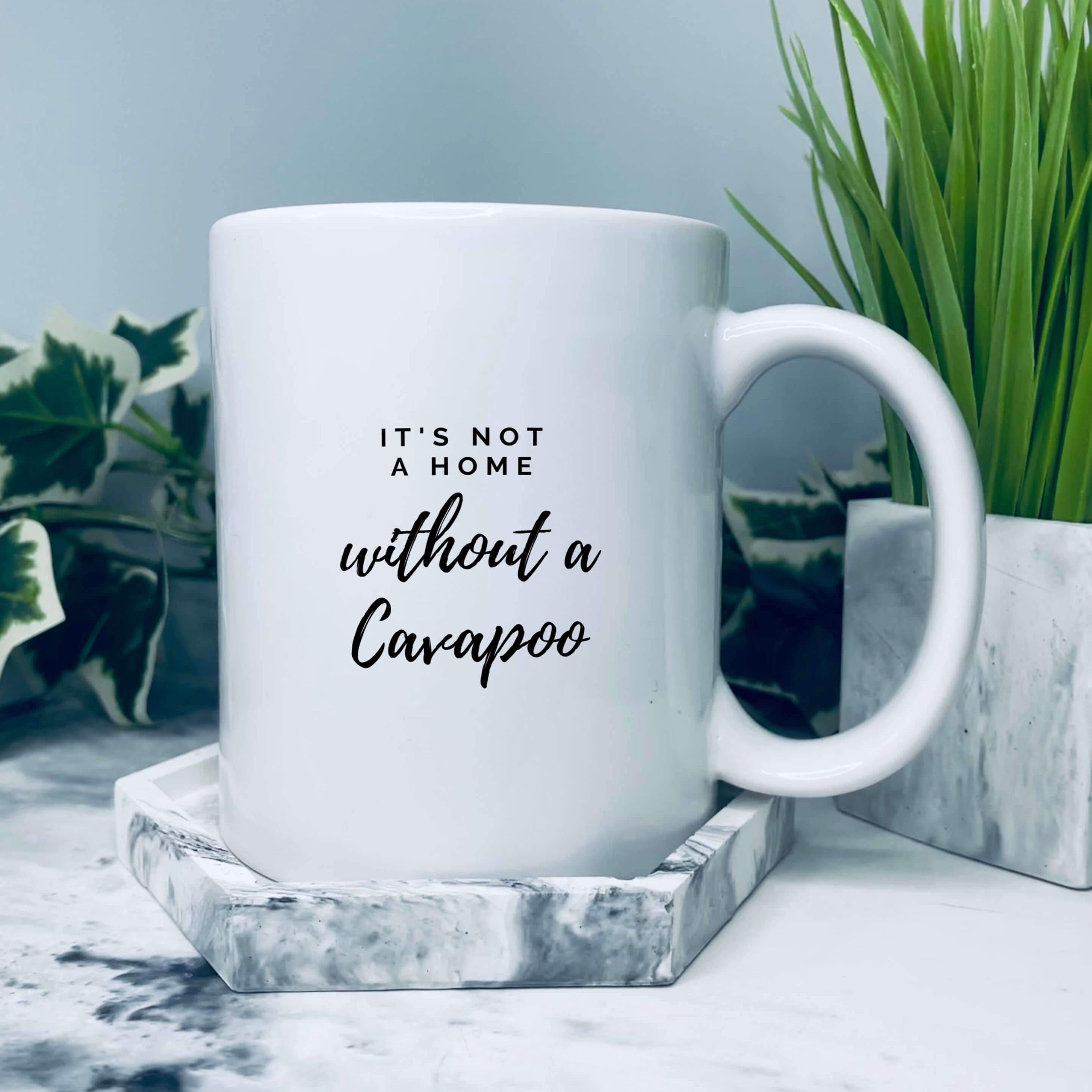 Mug with text on that says: It's not a home without a cavapoo